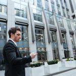 Man in big center using smartphone