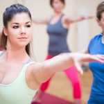 Group of people performing stretching exercise